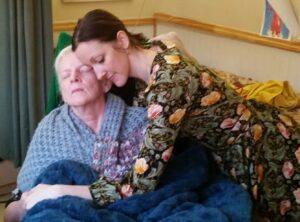 Daughter hugging her elderly mother